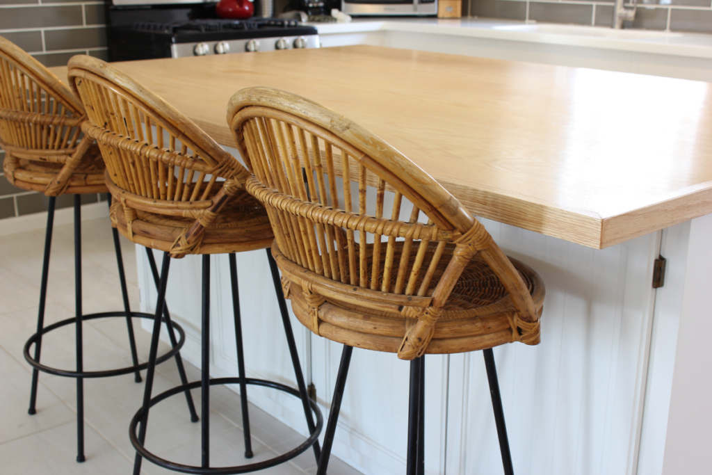 Three coastal style kitchen rattan stools.