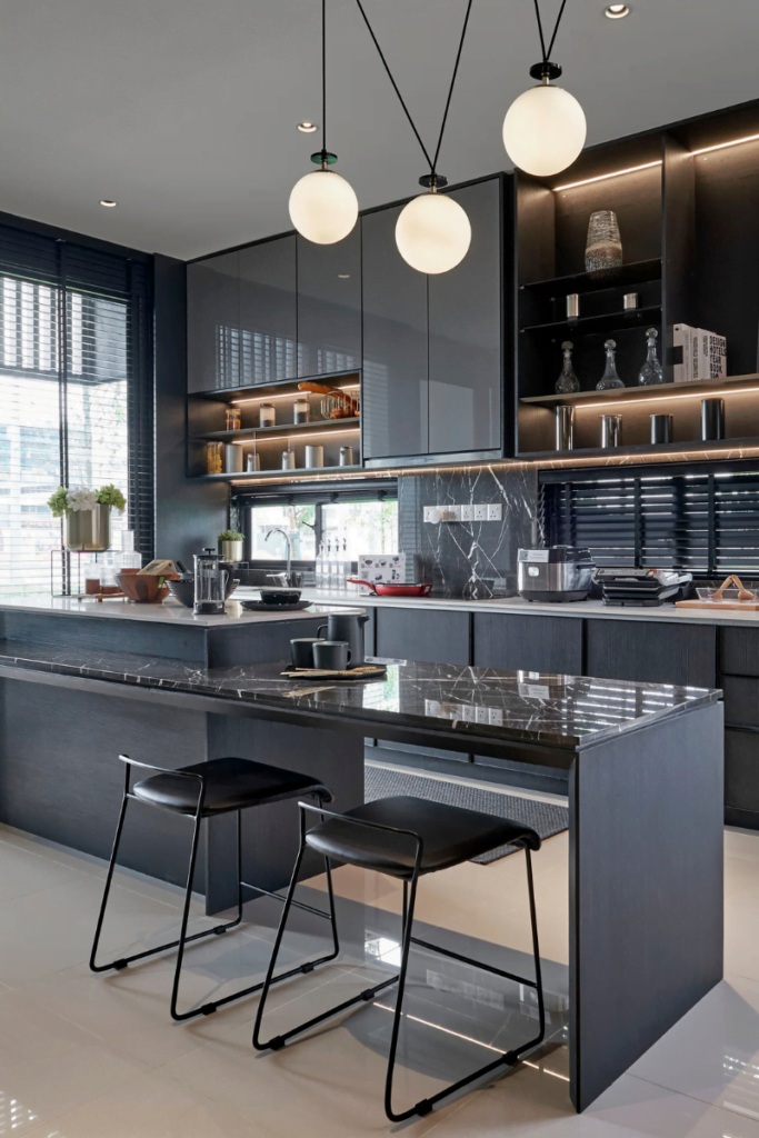 A modern kitchen with black cabinets and black counter tops transformed by Vinings Kitchen Remodeling Services.