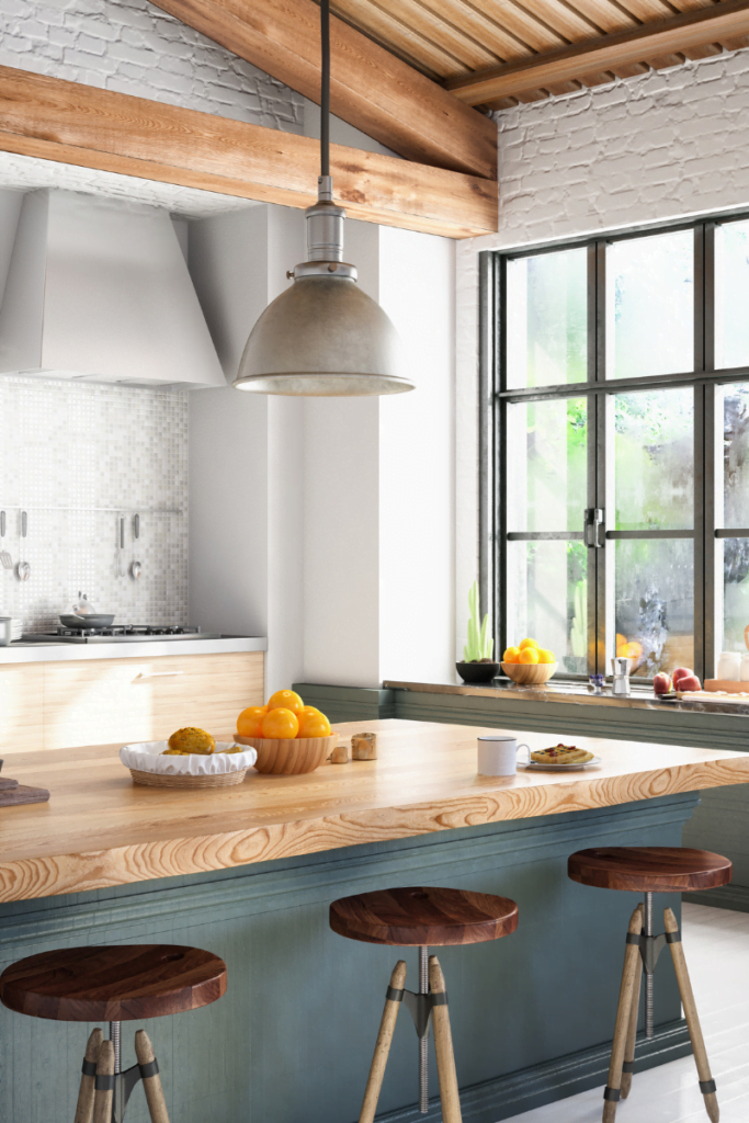 A kitchen with a wooden island and stools.