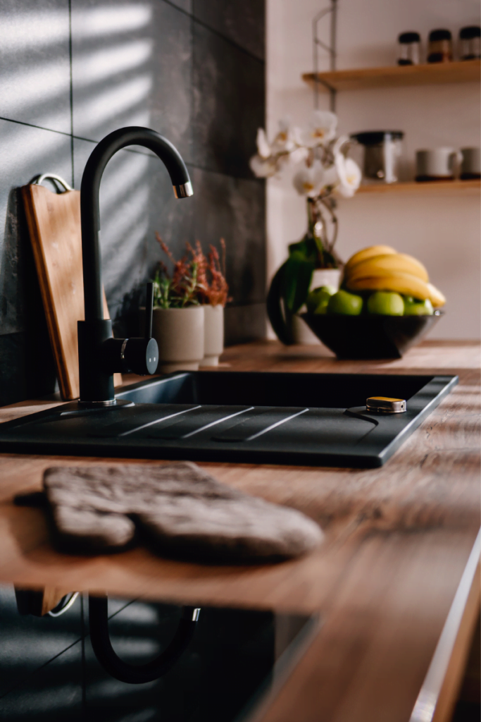 Woodstock Remodeling Services 1 A modern kitchen featuring a black sink.