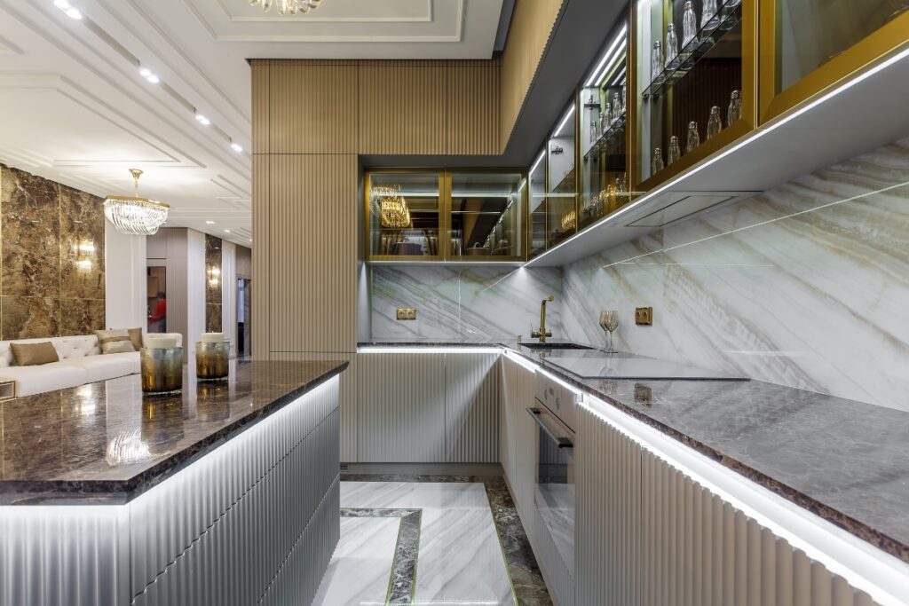 A modern kitchen with marble counter tops in various countertop colors for white kitchen cabinets.