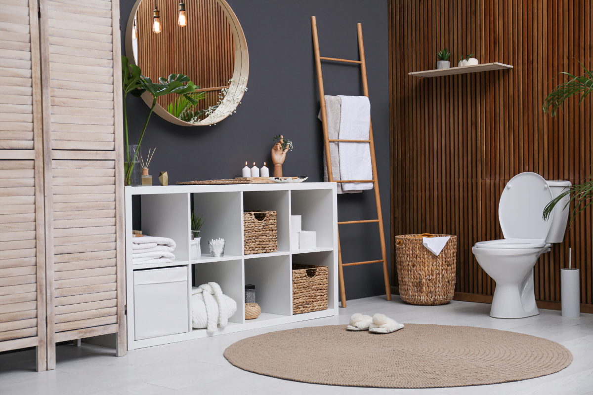 An eco friendly bathroom remodel featuring a white toilet and a wooden ladder.