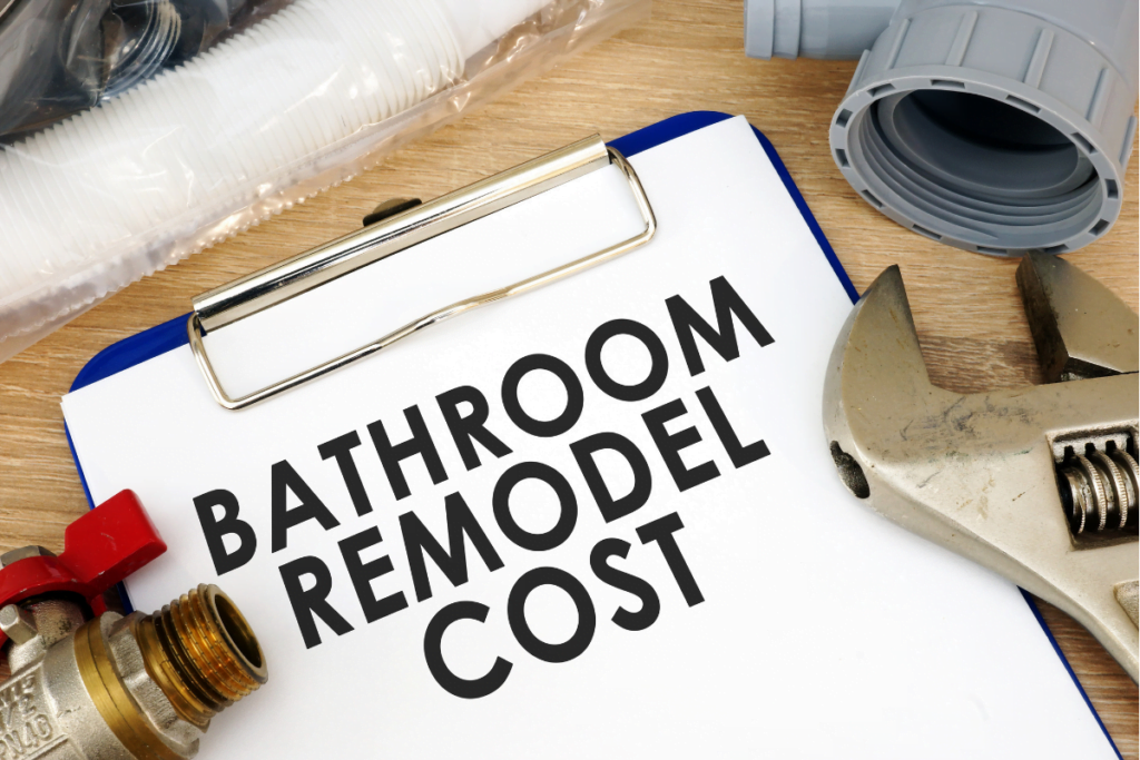 Clipboard with text "bathroom remodel cost" surrounded by plumbing tools and materials.