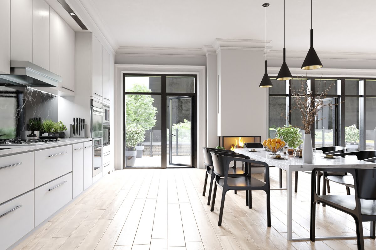 Modern kitchen and dining area with sleek cabinetry, black chairs, a marble table, and pendant lights. Large windows offer natural light and a view of greenery. Equipped with advanced home automation systems for ultimate convenience and efficiency.