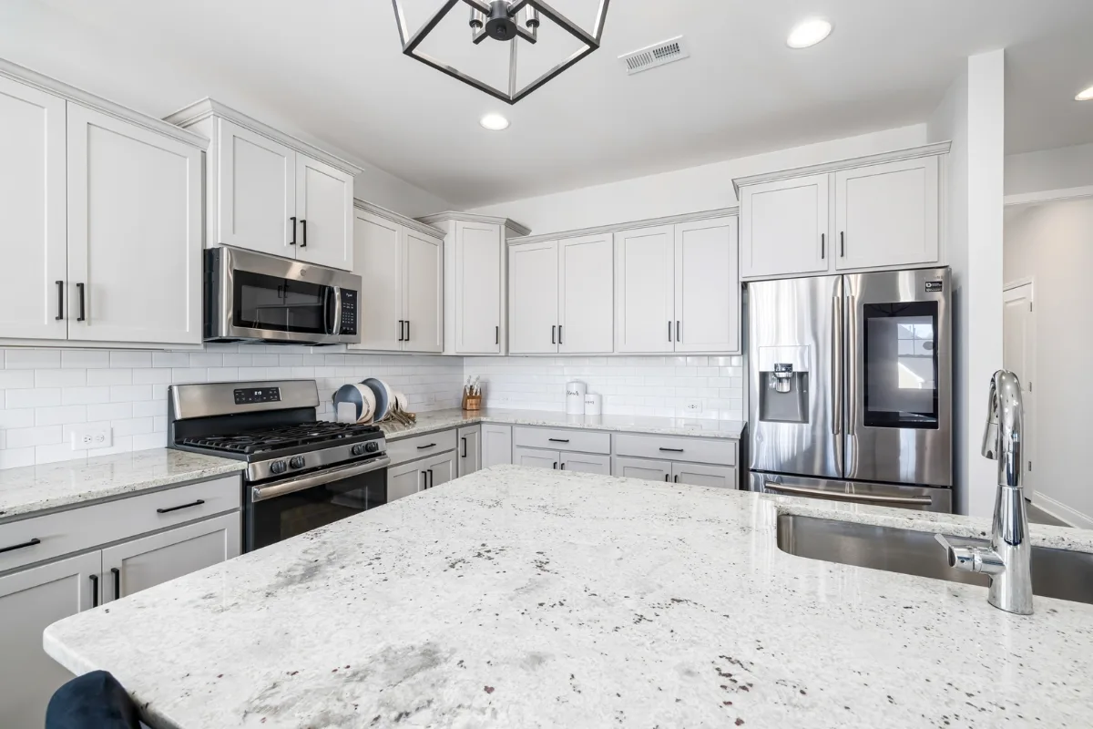 Top Kitchen Countertop Options for Your Sandy Springs Remodel 26 Discover a modern kitchen in Sandy Springs featuring sleek white cabinets, granite countertops, and stainless steel appliances. Homeowners will appreciate the large island with a sink, perfect for entertaining or meal prep.