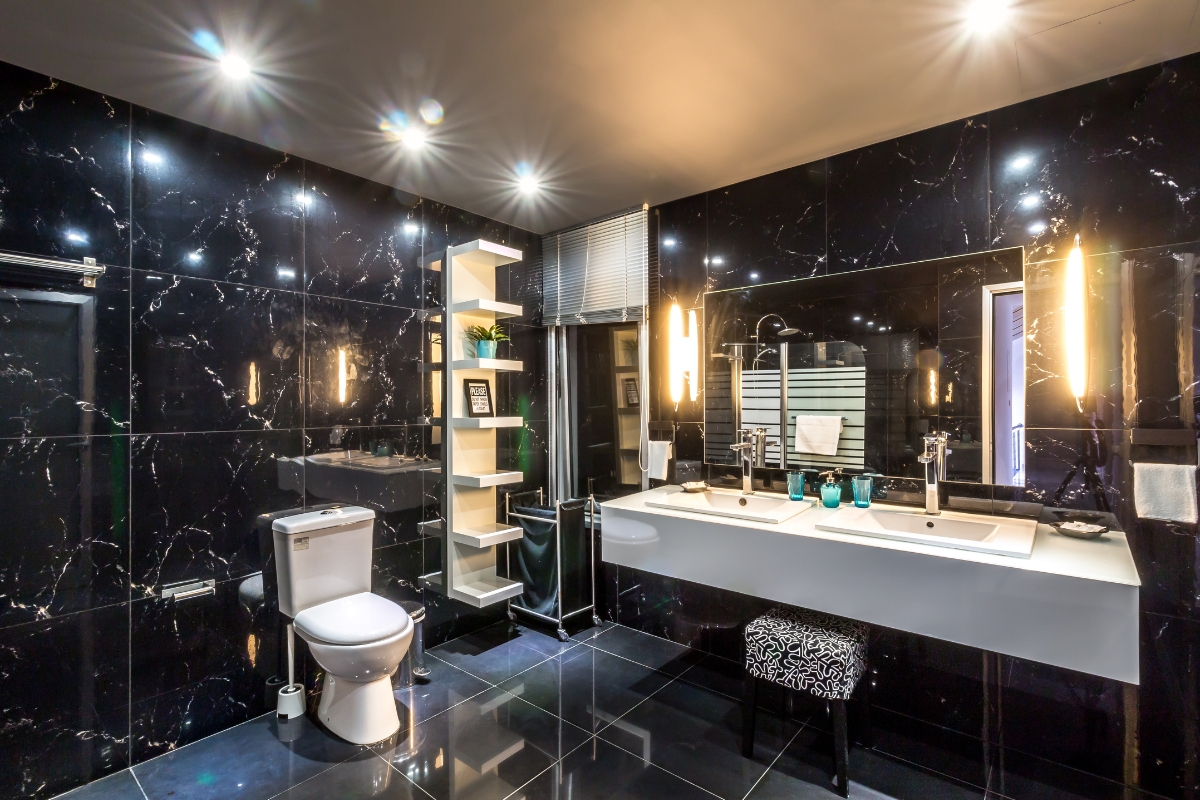 Bathroom Tile Flooring in Vinings: Expert Tips, Trends, and Benefits 5 Modern bathroom with black marble walls and bathroom tile flooring, double sink vanity with two mirrors, toilet, shelving, and bright overhead lighting.