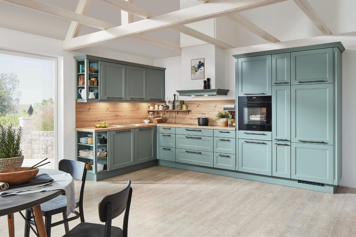Custom Kitchen Storage Solutions in Kennesaw: Maximize Your Space 4 Modern kitchen with light blue cabinets, wood countertops, built-in oven, open shelves, and a round dining table by a large window features custom kitchen storage for a seamless and organized space.