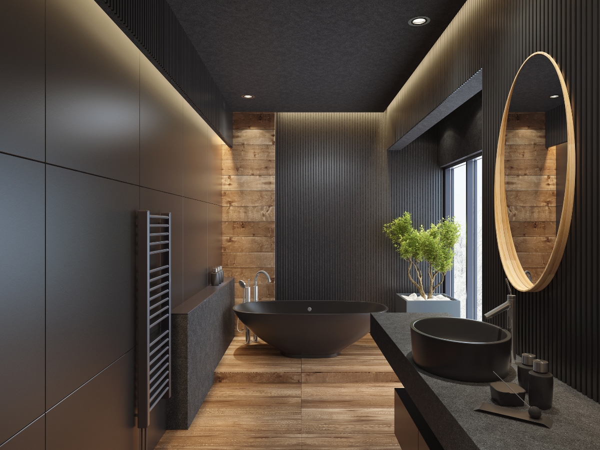 Bathroom Upgrades for the New Year: Best Renovation Ideas in Kennesaw GA 4 Modern bathroom upgrades shine with black fixtures, wood accents, a round mirror, freestanding bathtub, and a potted plant by a large window.