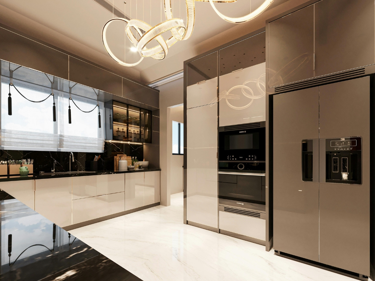 Modern kitchen staging highlights glossy cabinets, built-in appliances, a large refrigerator, sleek black countertops, and a contemporary chandelier. Marble floor and large window provide brightness.