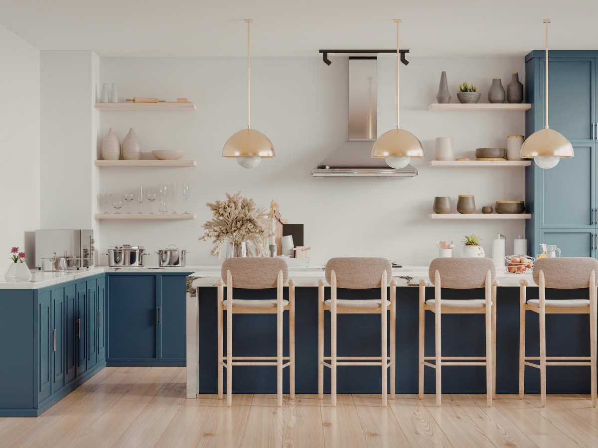 Modern kitchen staging with blue cabinets, a large island featuring beige barstools, open shelves displaying dishes, stylish pendant lights, and stainless steel appliances.