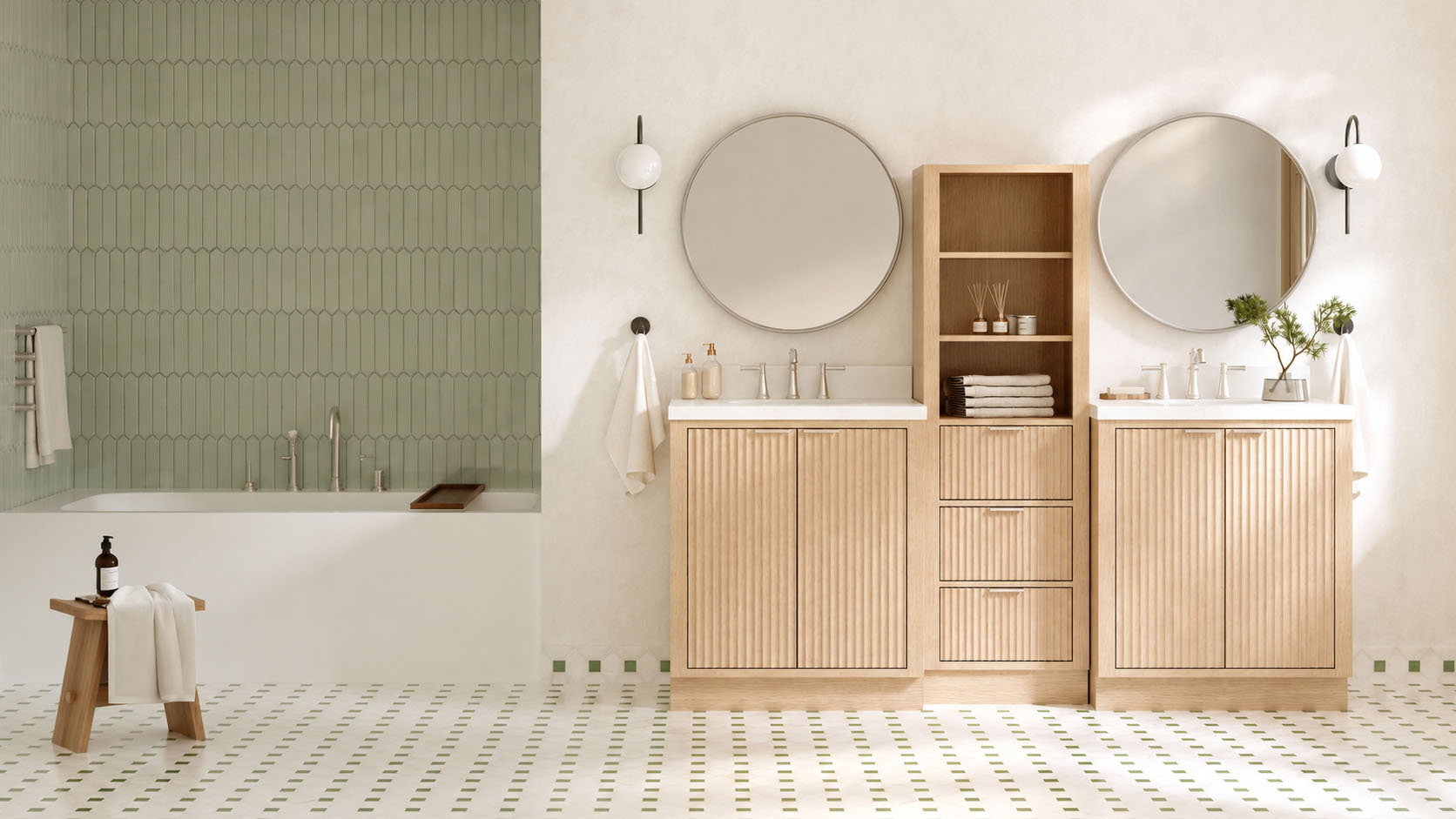Modern bathroom featuring two ARIEL bath vanities and storage, round mirrors, wall sconces, a built-in shelf with towels, and a bathtub adorned with green tile. The floor showcases a white and green geometric pattern, perfectly complementing the thoughtful cabinetry solutions throughout the space.